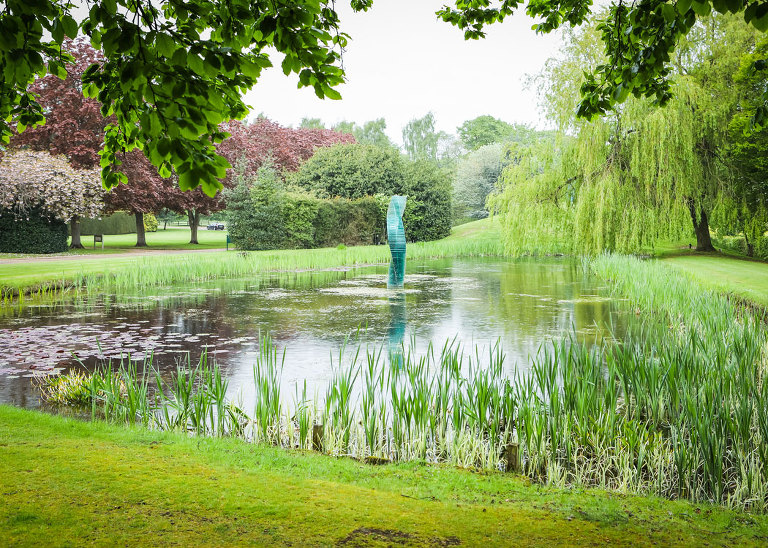The pond at Haughley Park Barn Wedding Venue on a wedding day with heavy rain photographed by Suffolk Wedding Photographers Hayley Denston Photography