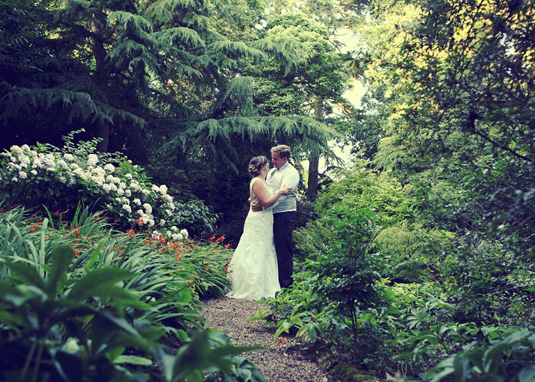 A bride and groom in the copse on their wedding day at Haughley Park Barn Wedding Venue photographed by Suffolk Wedding Photographers Hayley Denston Photography