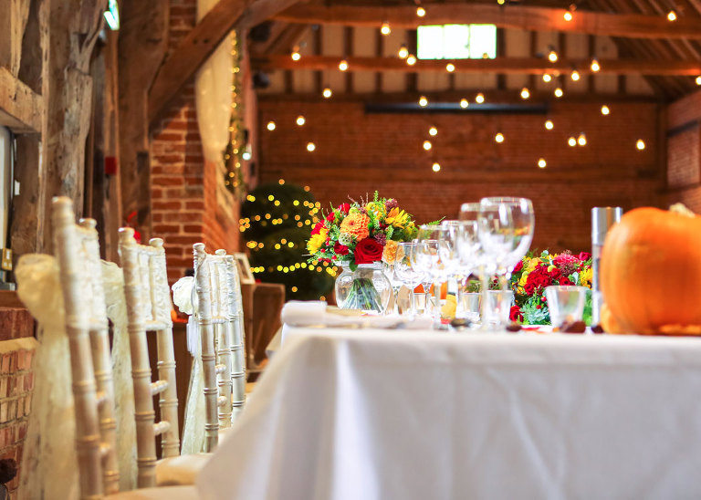 Decoratied floral Autumnal tables for a wedding reception at Haughley Park Barn Wedding Venue photographed by Suffolk Wedding Photographers Hayley Denston Photography