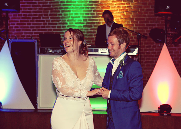 A bride and groom having their first dance in front of a disco at Haughley Park Barn Wedding Venue photographed by Suffolk Wedding Photographers Hayley Denston Photography