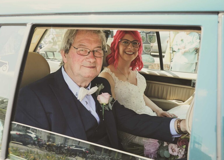A bride and her dad sat in a vintage mercedes car on her wedding day at Bury St Edmunds Registry Office in Suffolk captured by Suffolk Wedding Photographers Hayley Denston Photography
