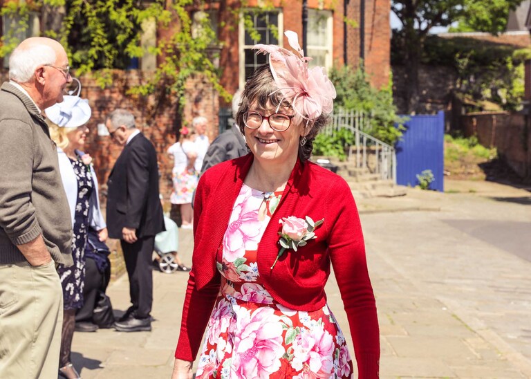 Guests laughing before the ceremony on a wedding day A grooms mum looking beautiful before a wedding ceremony at Bury St Edmunds Registry Office in Suffolk captured by Suffolk Wedding Photographers Hayley Denston Photography