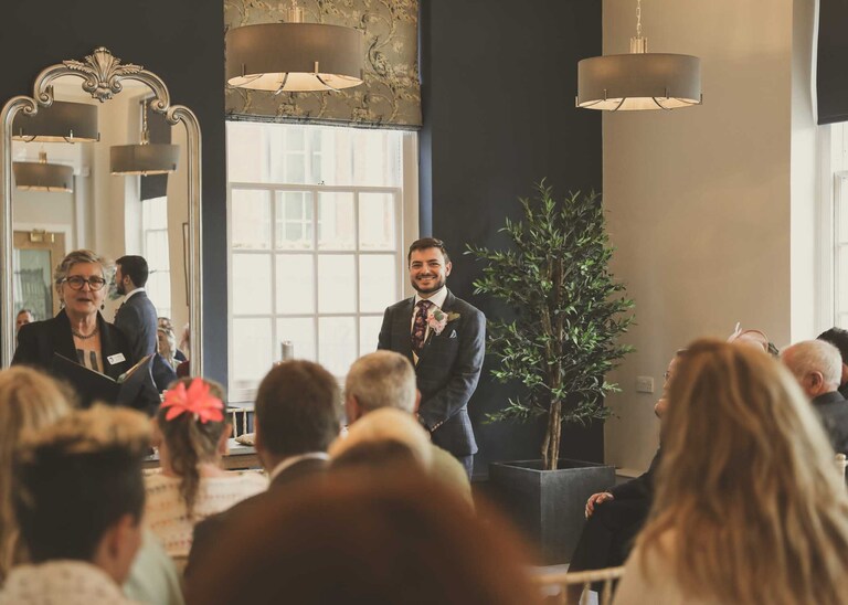 A groom waiting for his bride on his wedding day at Bury St Edmunds Registry Office in Suffolk captured by Suffolk Wedding Photographers Hayley Denston Photography