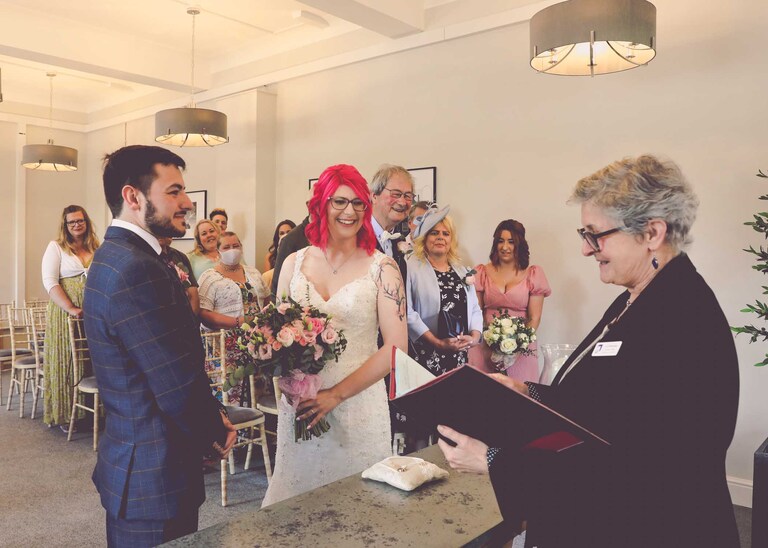 A bride and groom during their wedding ceremony at Bury St Edmunds Registry Office on their wedding day in Suffolk captured by Suffolk Wedding Photographers Hayley Denston Photography