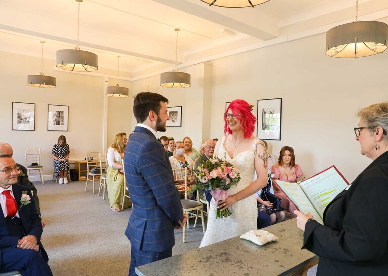 A bride and groom during their wedding ceremony at Bury St Edmunds Registry Office on their wedding day in Suffolk captured by Suffolk Wedding Photographers Hayley Denston Photography