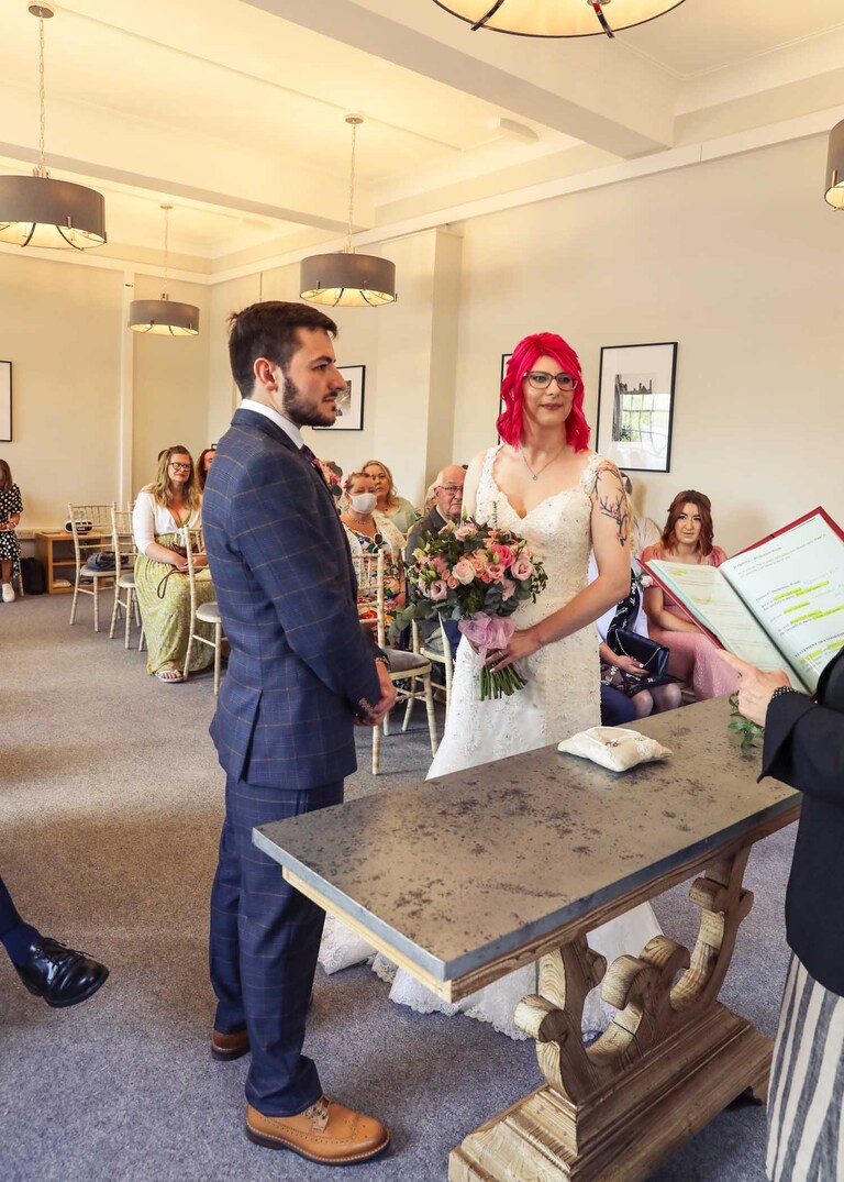A bride and groom during their wedding ceremony at Bury St Edmunds Registry Office on their wedding day in Suffolk captured by Suffolk Wedding Photographers Hayley Denston Photography