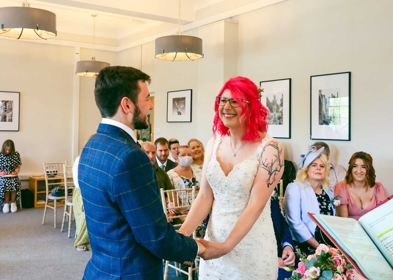 A bride and groom during their wedding ceremony at Bury St Edmunds Registry Office on their wedding day in Suffolk captured by Suffolk Wedding Photographers Hayley Denston Photography