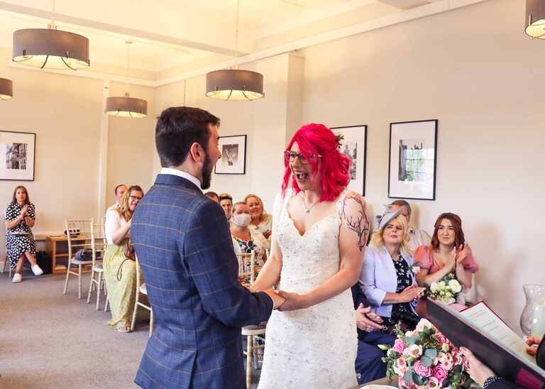 A bride and groom during their wedding ceremony at Bury St Edmunds Registry Office on their wedding day in Suffolk captured by Suffolk Wedding Photographers Hayley Denston Photography