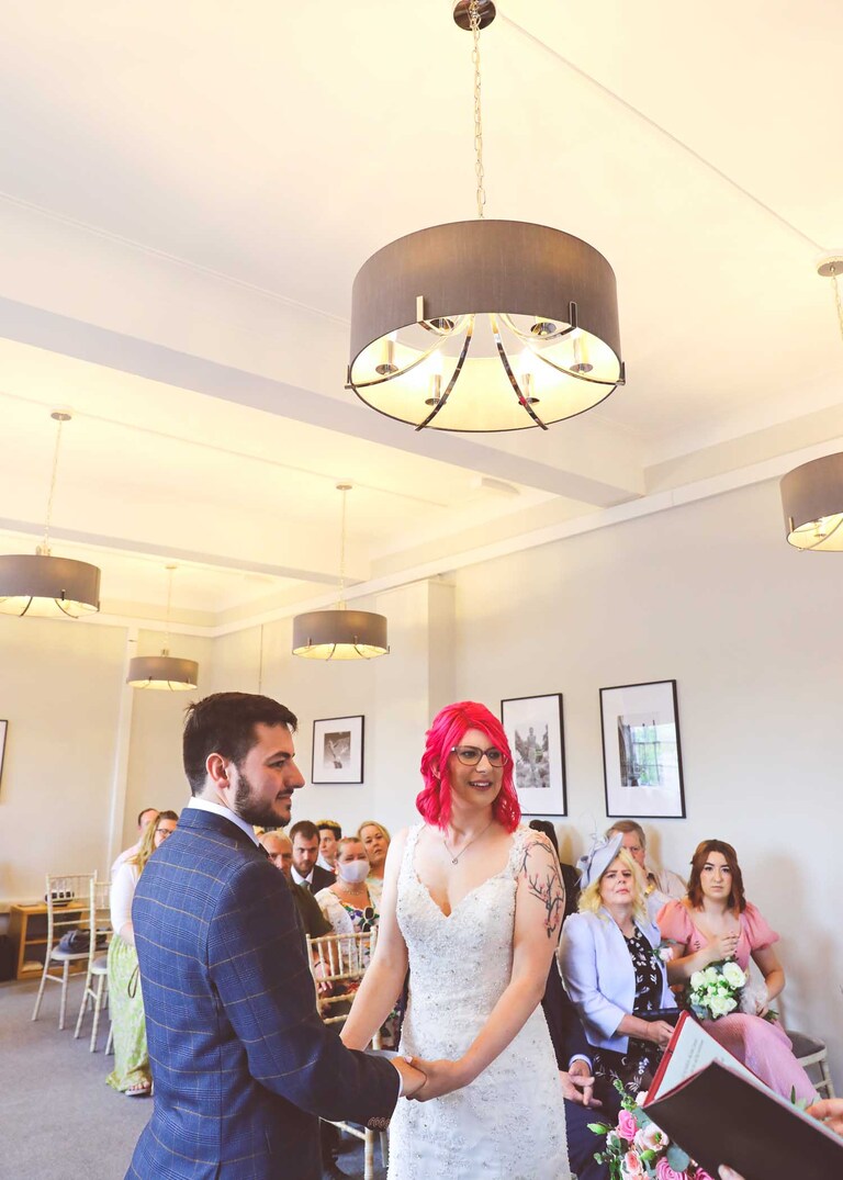 A bride and groom during their wedding ceremony at Bury St Edmunds Registry Office on their wedding day in Suffolk captured by Suffolk Wedding Photographers Hayley Denston Photography