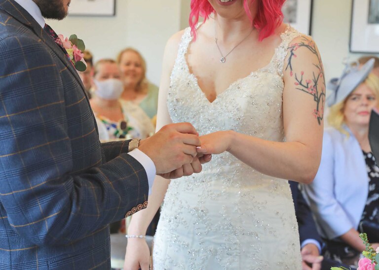A bride and groom during their wedding ceremony at Bury St Edmunds Registry Office on their wedding day in Suffolk captured by Suffolk Wedding Photographers Hayley Denston Photography