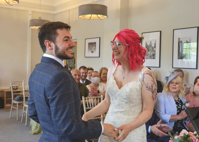A bride and groom during their wedding ceremony at Bury St Edmunds Registry Office on their wedding day in Suffolk captured by Suffolk Wedding Photographers Hayley Denston Photography