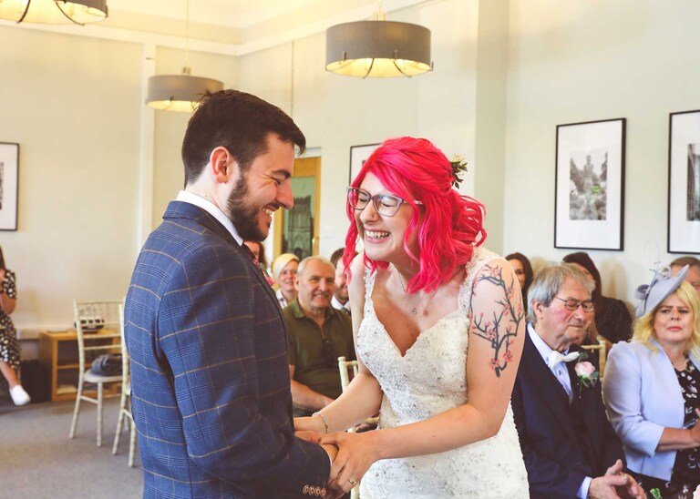 A bride and groom during their wedding ceremony at Bury St Edmunds Registry Office on their wedding day in Suffolk captured by Suffolk Wedding Photographers Hayley Denston Photography