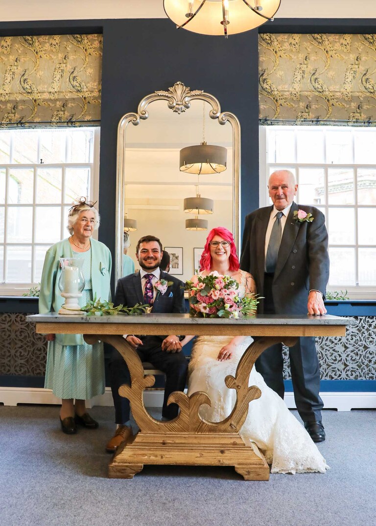 A bride and groom and their witnesses at a wedding ceremony at Bury St Edmunds Registry Office on a wedding day in Suffolk captured by Suffolk Wedding Photographers Hayley Denston Photography