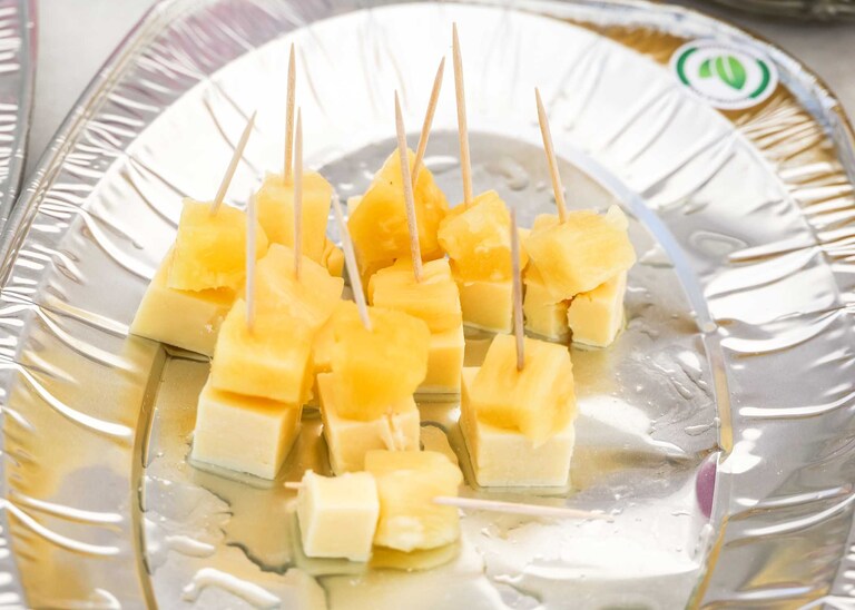 Cheese and pineapple on sticks at a wedding reception on a wedding day in Suffolk captured by Suffolk Wedding Photographers Hayley Denston Photography