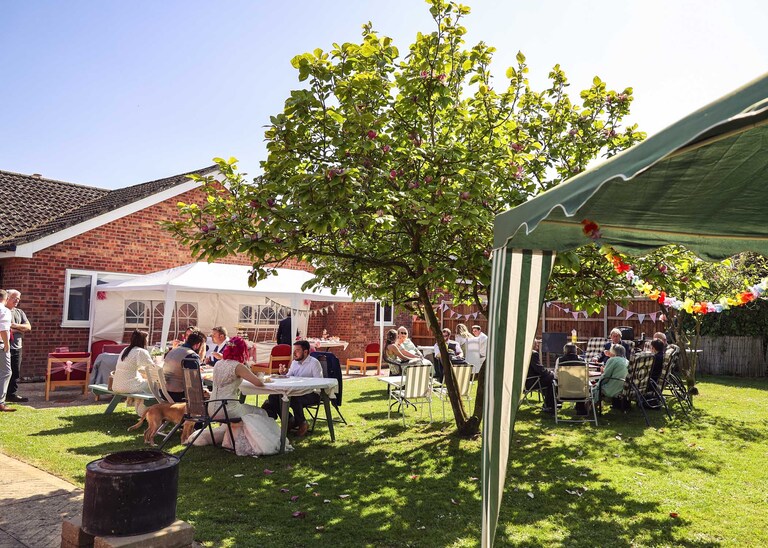 A back garden wedding reception on a wedding day in Suffolk captured by Suffolk Wedding Photographers Hayley Denston Photography