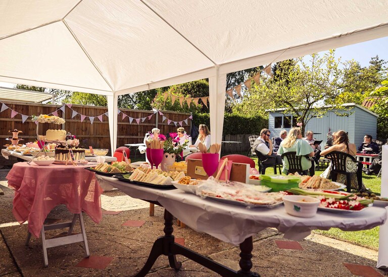 An afternoon tea in a garden on a wedding day in Suffolk captured by Suffolk Wedding Photographers Hayley Denston Photography