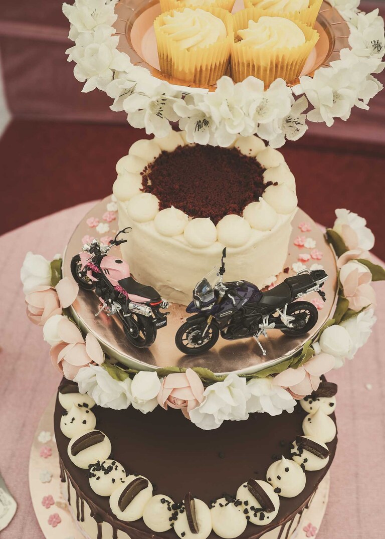 A wedding cake with mini motorbikes on a wedding day in Suffolk captured by Suffolk Wedding Photographers Hayley Denston Photography