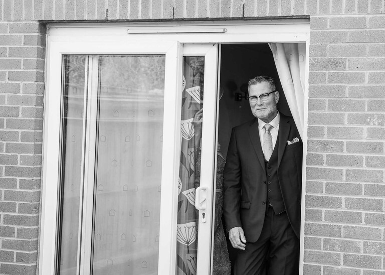 A dad seeing his daughter in her wedding dress for the first time at Hungarian Hall on a Wedding Day photographed by Suffolk Wedding Photographers Hayley Denston Photography