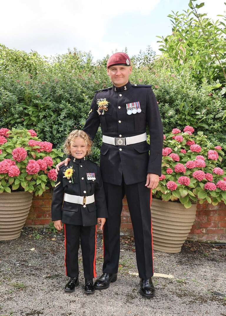 A groom and his son the pageboy both dressed in ones before his wedding ceremony at Hungarian Hall on a Wedding Day photographed by Suffolk Wedding Photographers Hayley Denston Photography