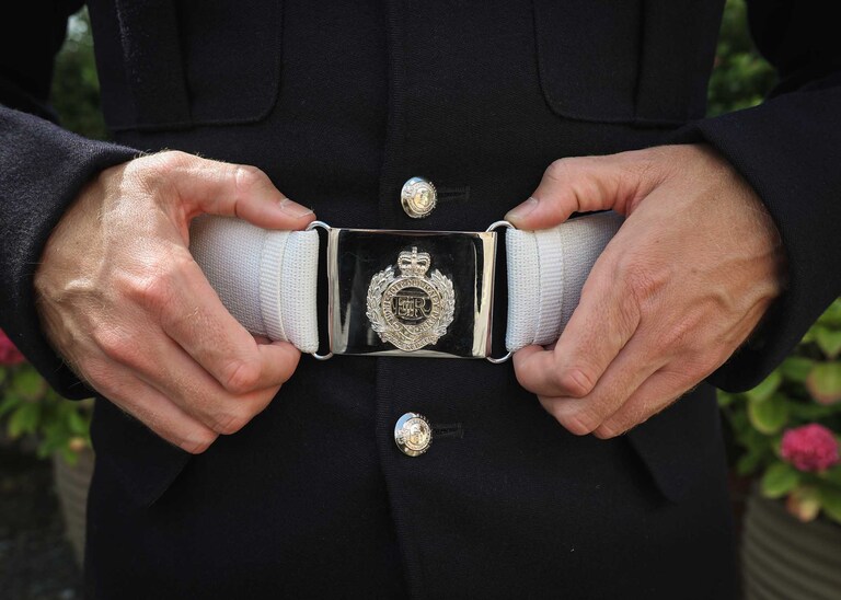 A grooms ones belt with his hands holding the buckle at Hungarian Hall on a Wedding Day photographed by Suffolk Wedding Photographers Hayley Denston Photography