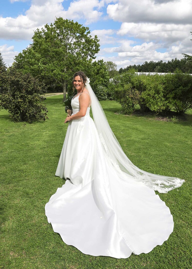 A bride with her train out on her wedding day at Hungarian Hall on a Wedding Day photographed by Suffolk Wedding Photographers Hayley Denston Photography