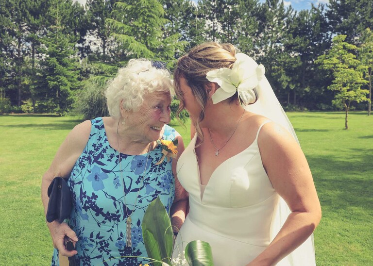 A bride laughing with her nan at Hungarian Hall on a Wedding Day photographed by Suffolk Wedding Photographers Hayley Denston Photography