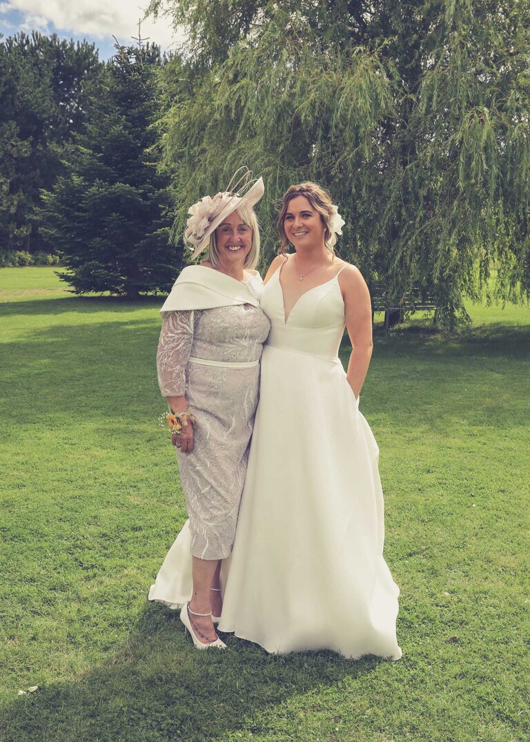 A bride and her mum formal photo at Hungarian Hall on a Wedding Day photographed by Suffolk Wedding Photographers Hayley Denston Photography