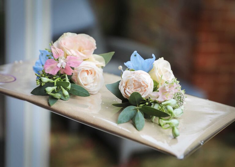 Pastel buttonholes on a rainy wedding day at Letheringham Water Mill by Suffolk Wedding Photographers Hayley Denston Photography