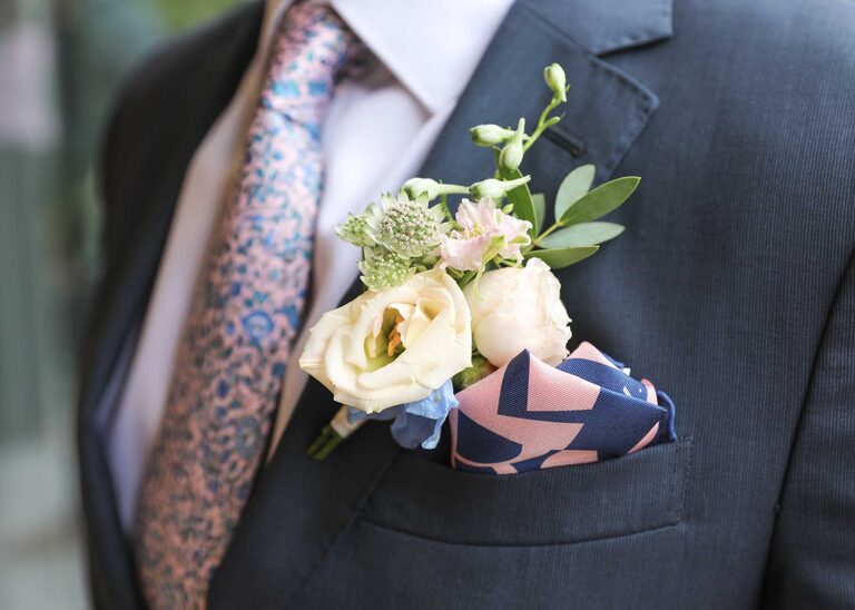 A grooms pastel buttonhole on a rainy wedding day by Suffolk Wedding Photographers Hayley Denston Photography