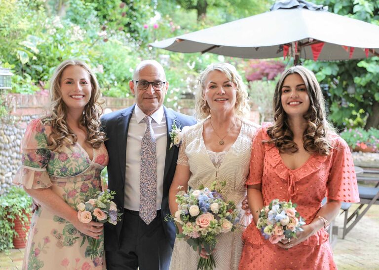 A bride and groom and her daughters at Letheringham Water Mill on a wedding day by Suffolk Wedding Photographers Hayley Denston Photography