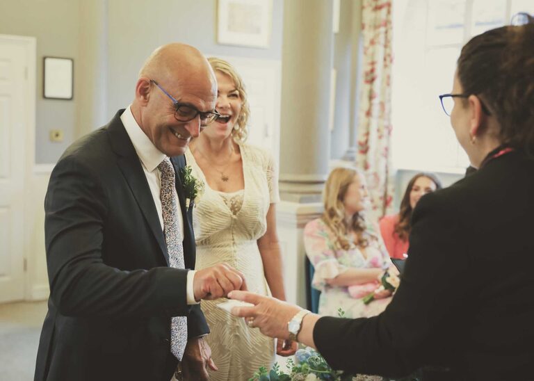 A bride and groom exchanging rings at a wedding ceremony at Woodbridge Shire Hall photographed by Suffolk Wedding Photographers Hayley Denston Photography