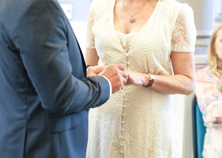 A bride and groom exchanging rings at a wedding ceremony at Woodbridge Shire Hall photographed by Suffolk Wedding Photographers Hayley Denston Photography