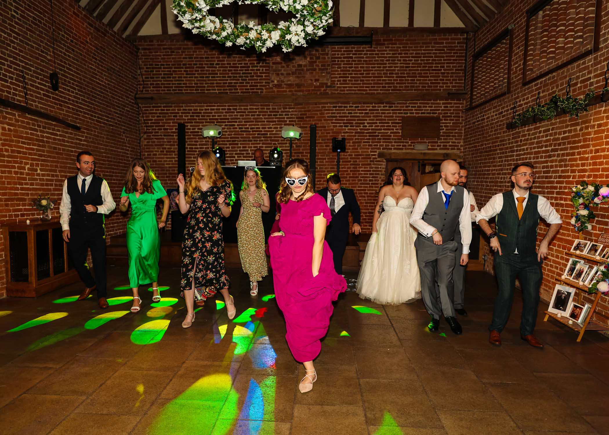 A bridal party dancing at a wedding at Haughley Park Barn taken by Suffolk Wedding Photographer Hayley Denston Photography
