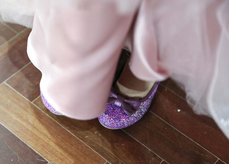 Bright sparkly purple flowergirl shoes at a wedding at Ipswich Town Hall taken by Suffolk Wedding Photographer Hayley Denston Photography