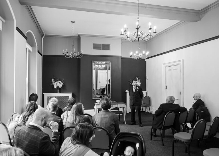 A groom in the ceremony room at Ipswich Town Hall taken by Suffolk Wedding Photographer Hayley Denston Photography