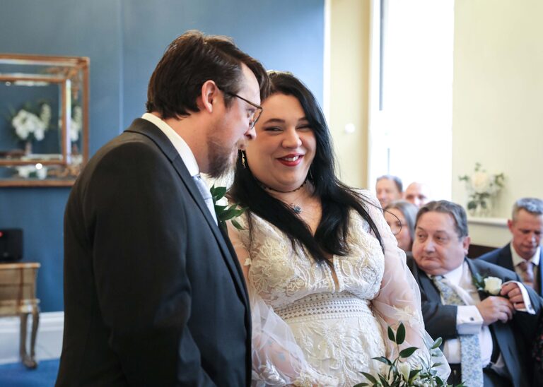 A bride looking at her groom during their ceremony at Ipswich Town Hall taken by Suffolk Wedding Photographer Hayley Denston Photography
