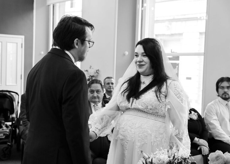 A bride and groom facing each other exchanging vows during their ceremony at Ipswich Town Hall taken by Suffolk Wedding Photographer Hayley Denston Photography