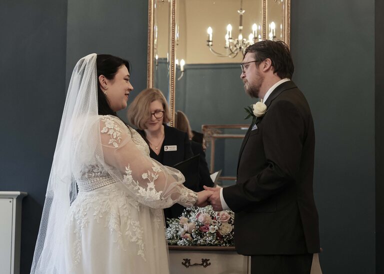 A bride and groom holding hands and exchanging wedding vows at a wedding ceremony at Ipswich Town Hall taken by Suffolk Wedding Photographer Hayley Denston Photography