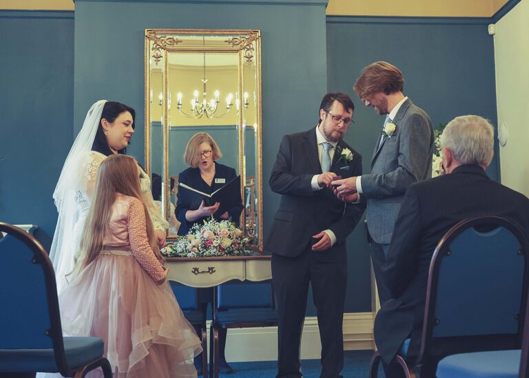 A groom getting his brides ring from the bestman during their wedding ceremony at Ipswich Town Hall taken by Suffolk Wedding Photographer Hayley Denston Photography