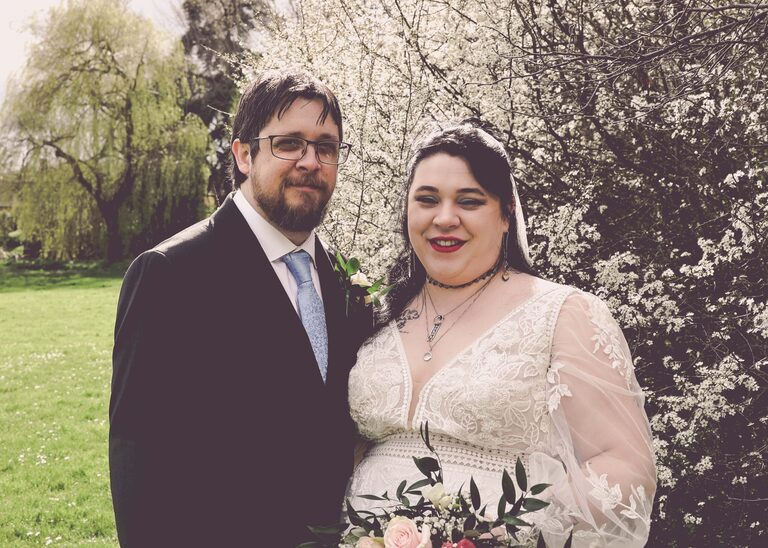 A bride and groom on their suffolk wedding day in front of a white flowering cherry taken by Suffolk Wedding Photographer Hayley Denston Photography