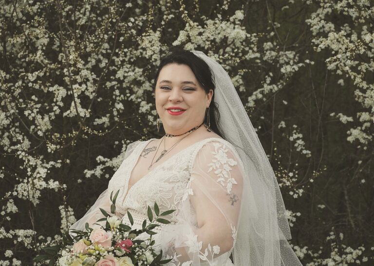 A bride on her suffolk wedding day in front of a white flowering cherry taken by Suffolk Wedding Photographer Hayley Denston Photography