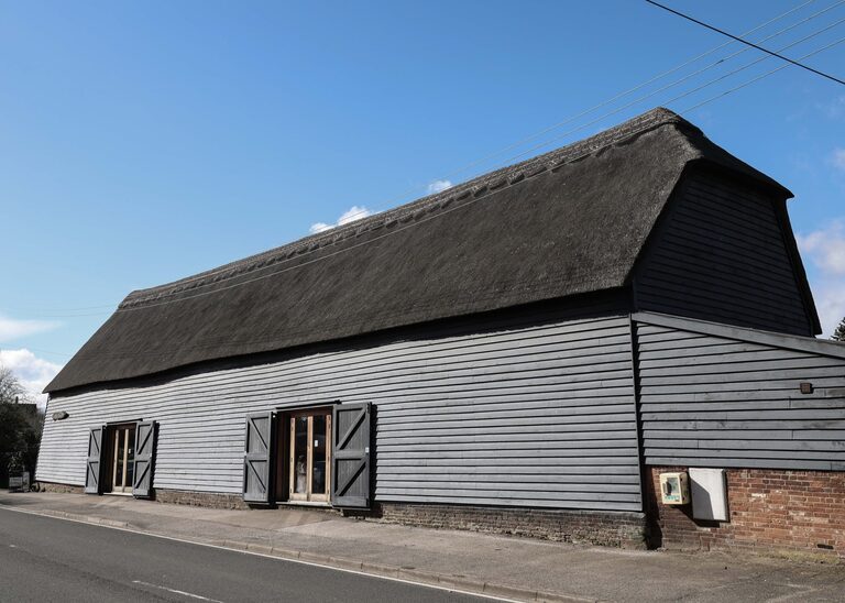 The tithe barn in Sproughton on a wedding day with bright blue skies taken by Suffolk Wedding Photographer Hayley Denston Photography