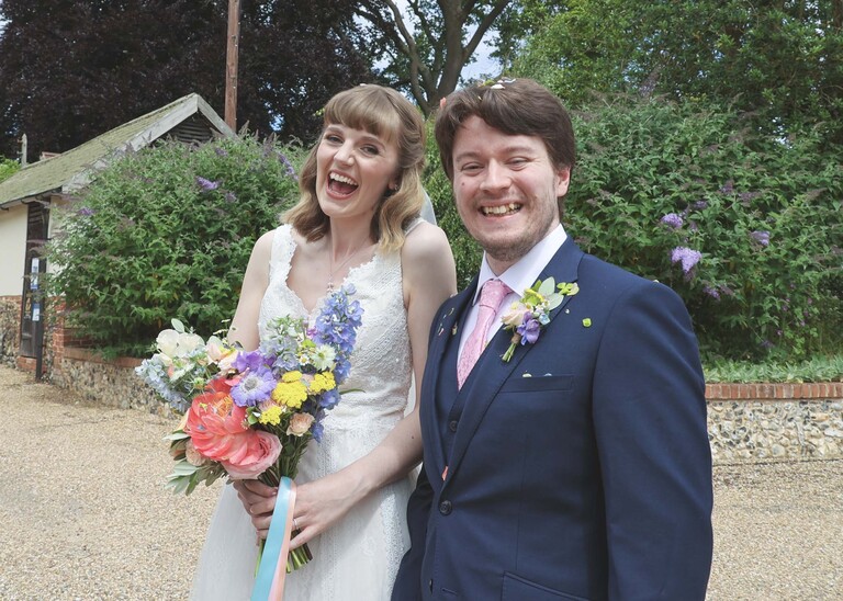 A bride and groom laughing on a wedding day at Bressingham Hall and High Barn captured by Suffolk Wedding Photographers Hayley Denston Photography