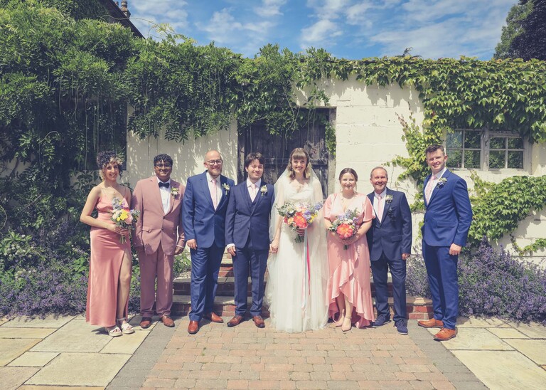 A bridal party group photo on a wedding day at Bressingham Hall and High Barn captured by Suffolk Wedding Photographers Hayley Denston Photography