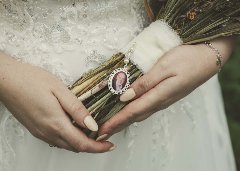 A charm of a grandad on a brides bouquet on her wedding day at the Garden Barn, Little Bradley captured by Hayley Denston Photography