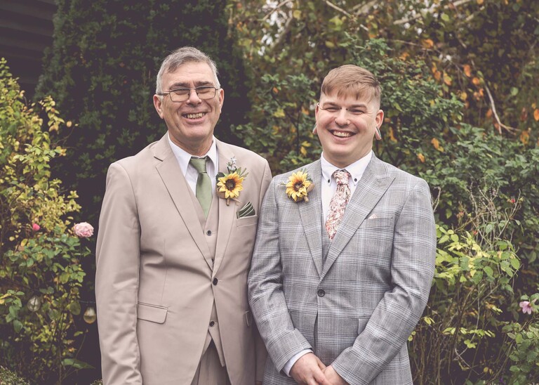 A groom and his dad laughing on a wedding day at the Garden Barn, Little Bradley captured by Hayley Denston Photography