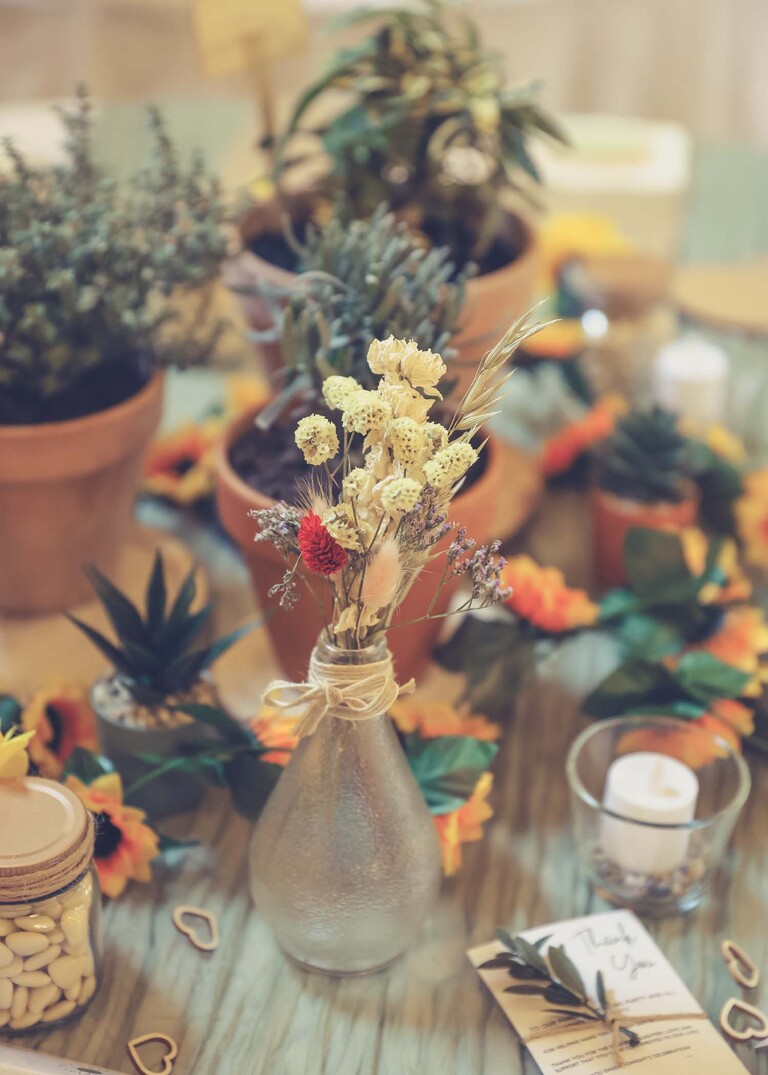 Dried flowers as part of a table centre piece on a wedding day at the Garden Barn, Little Bradley captured by Hayley Denston Photography
