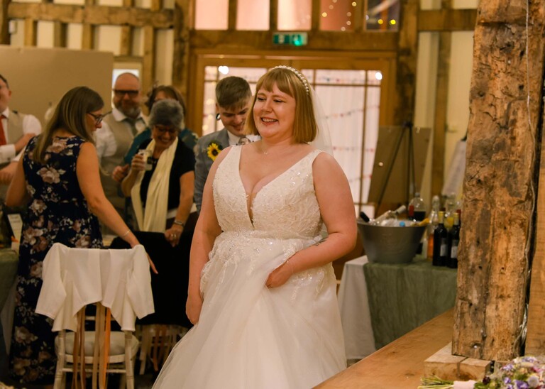 A bride leading her groom to their table for their wedding breakfast on their wedding day at the Garden Barn, Little Bradley captured by Hayley Denston Photography