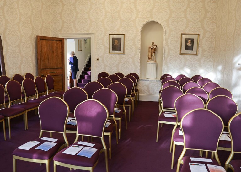 The inside of the John Milton Ceremony room with purple chairs at stowmarket registry office photographed by Suffolk Wedding Photographer Hayley Denston Photography