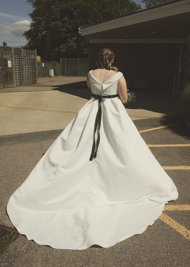 The back of a brides big wedding dress photographed by Suffolk Wedding Photographer Hayley Denston Photography
